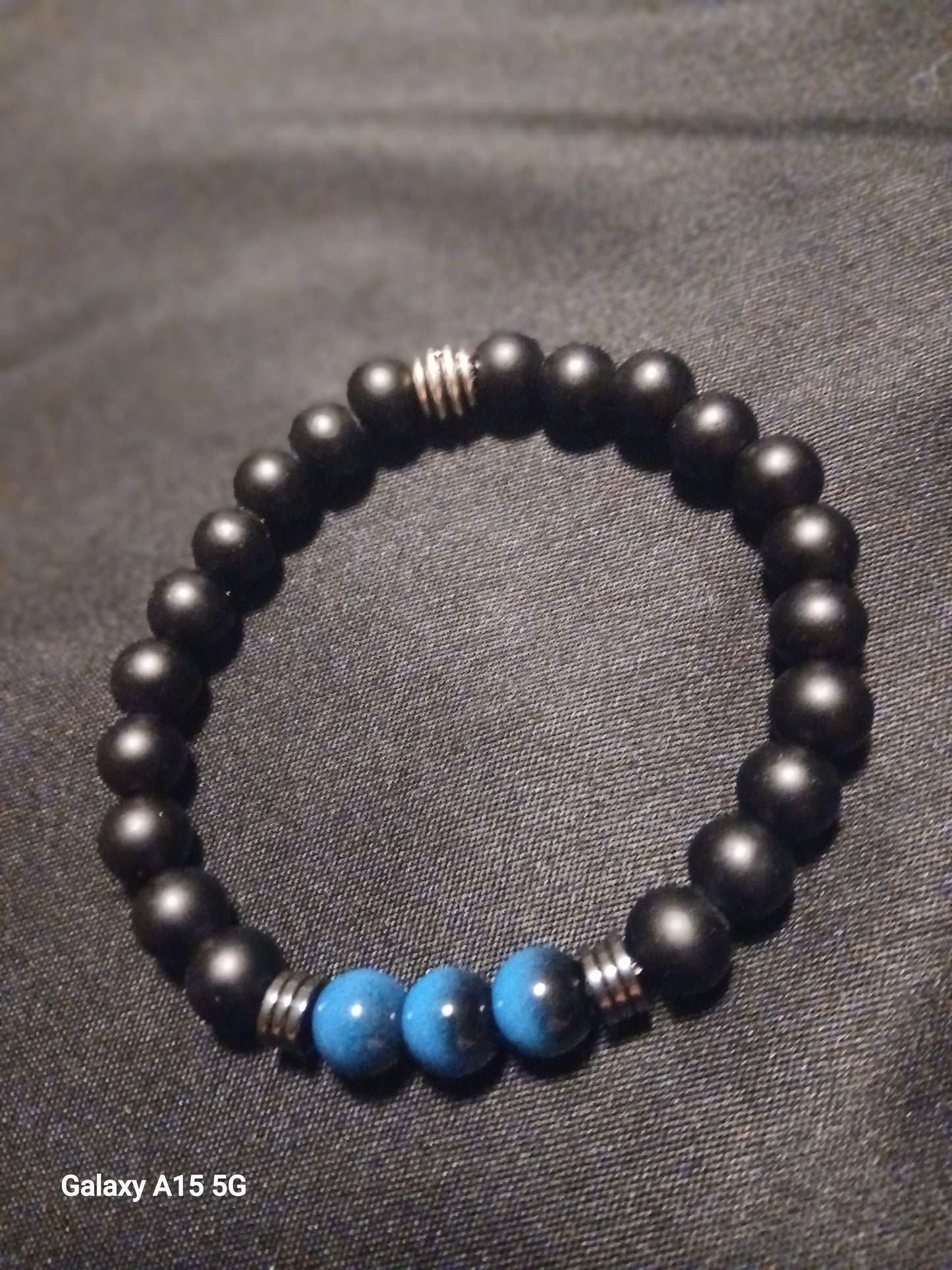 Black onyx beaded bracelet with turquoise accent beads and silver spacers